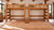 Lodge Barnwood side-by-side Queen loft beds with shared slanted center ladder and access platform, open space below both loft beds.
