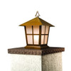 A classic, traditional sloped-roof column mounted pier light fixture with crown molding accent, an aged bronze finish and warm white glass. 