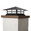 A classic, traditional sloped-roof column mounted pier light fixture with crown molding accent, a black finish and white glass. 