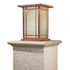 A rectangular, vertical column mounted pier light fixture with a raw copper finish and dappled white glass.