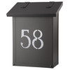 A classic, solid brass, vertical mailbox with a black finish and glass-backed house address numbers. 