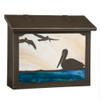 A large brass mailbox with a bronze finish, warm toned glass and artwork featuring a trio of pelicans on the ocean. 