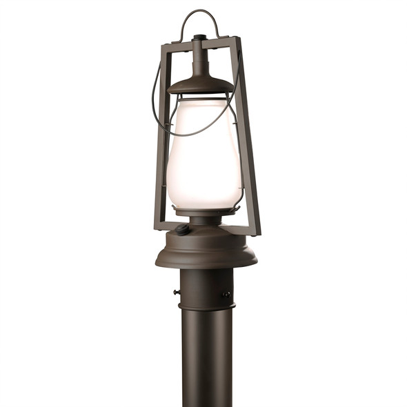 A rustic reproduction of a 19th-century, Dietz hot blast post mounted lantern from the frontier days of the Wild West with a bronzed finish and frosted shade.