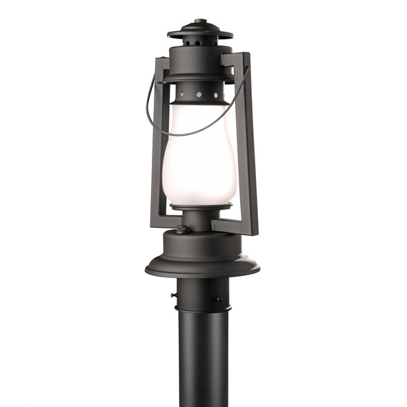 A rustic reproduction of a 19th-century, Dietz cold blast post mounted landscape light from the frontier days of the Wild West with a black finish and frosted shade.