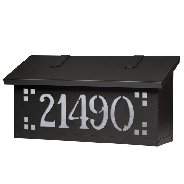 A horizontal brass mailbox with a black finish, glass corner accents and address numbers on the front backed by glass. 