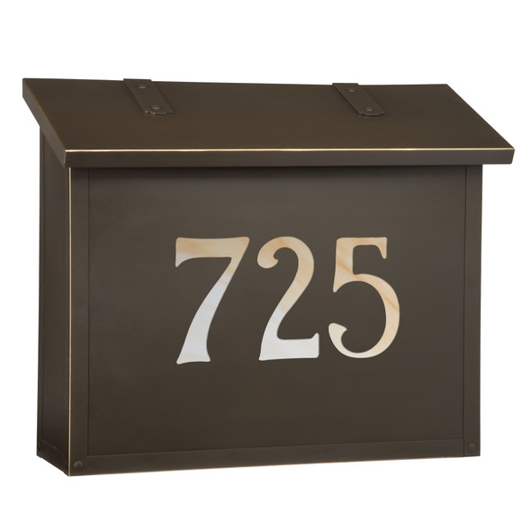 A classic, solid brass, large mailbox with an oil rubbed bronze finish and glass-backed house address numbers. 