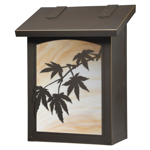 A vertical brass mailbox with a bronze finish, warm toned glass and Japanese Maple filigree artwork. 