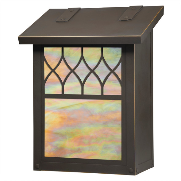 A vertical brass metal mailbox with a design inspired by cathedral windows. The mailbox has a bronze finish and iridescent glass.