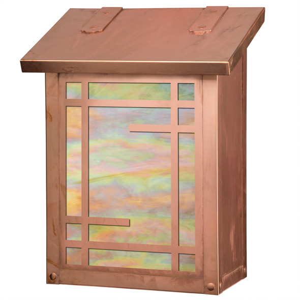 A vertical brass  mailbox with a raw copper finish, iridescent glass and a geometric design that suggests a Japanese shoji screen.