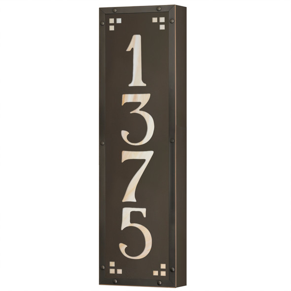 A solid brass, vertically oriented illuminated house number plaque with a four number address, a bronze finish, warm glass and corner glass accents.