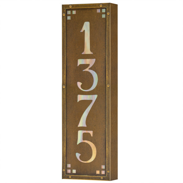 A solid brass, vertically oriented illuminated house number plaque with a four number address, an aged finish, iridescent glass and corner glass accents.