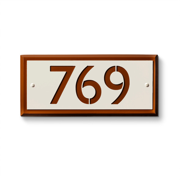 Contemporary metal address sign featuring orange bronze frame with white background and cut-out numerals "769" for dimensional effect. American-made address plaque with contrasting finish ideal for multi-unit property and hotel identification applications 
