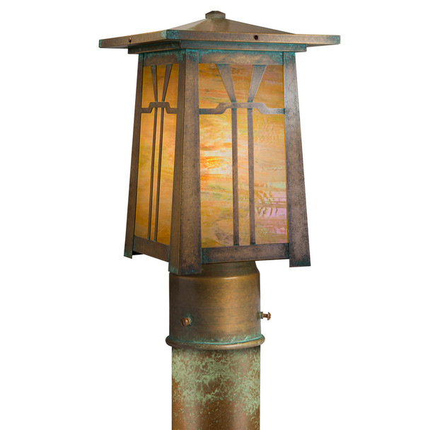 A linear Arts & Crafts post mounted light fixture with an aged patina, golden glass and a Gamble House design.