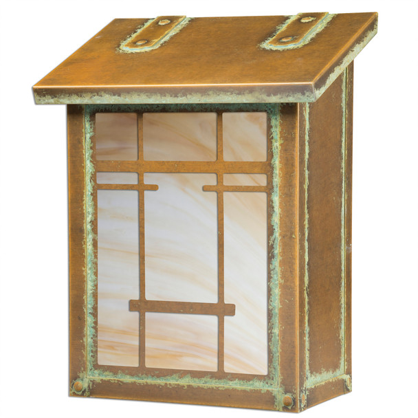 A vertical brass mailbox with an aged patina finish, warm toned glass and a filigree pattern inspired by Japanese architecture.