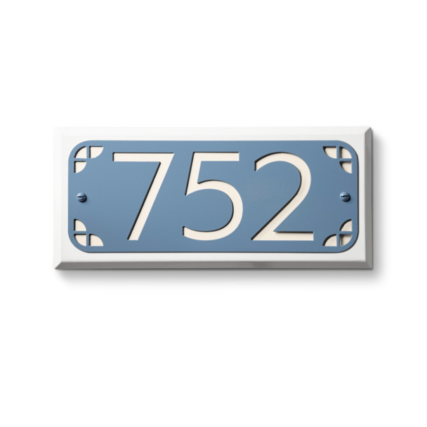 Metal address plaque in blue finish with white background featuring cut-out numerals "752" and decorative corner circle elements. American-made address sign with rounded corner design ideal for contemporary property and hotel applications 