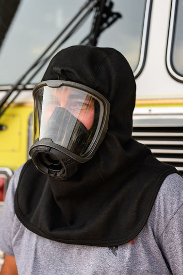 Firefighter wearing a FORTEX particulate hood with SCBA facepiece