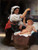 Fine Art Prints A woman offers grapes to a baby in a crib, depicted in "A Bunch of Grapes" by William-Adolphe Bouguereau, 16x21 inches.