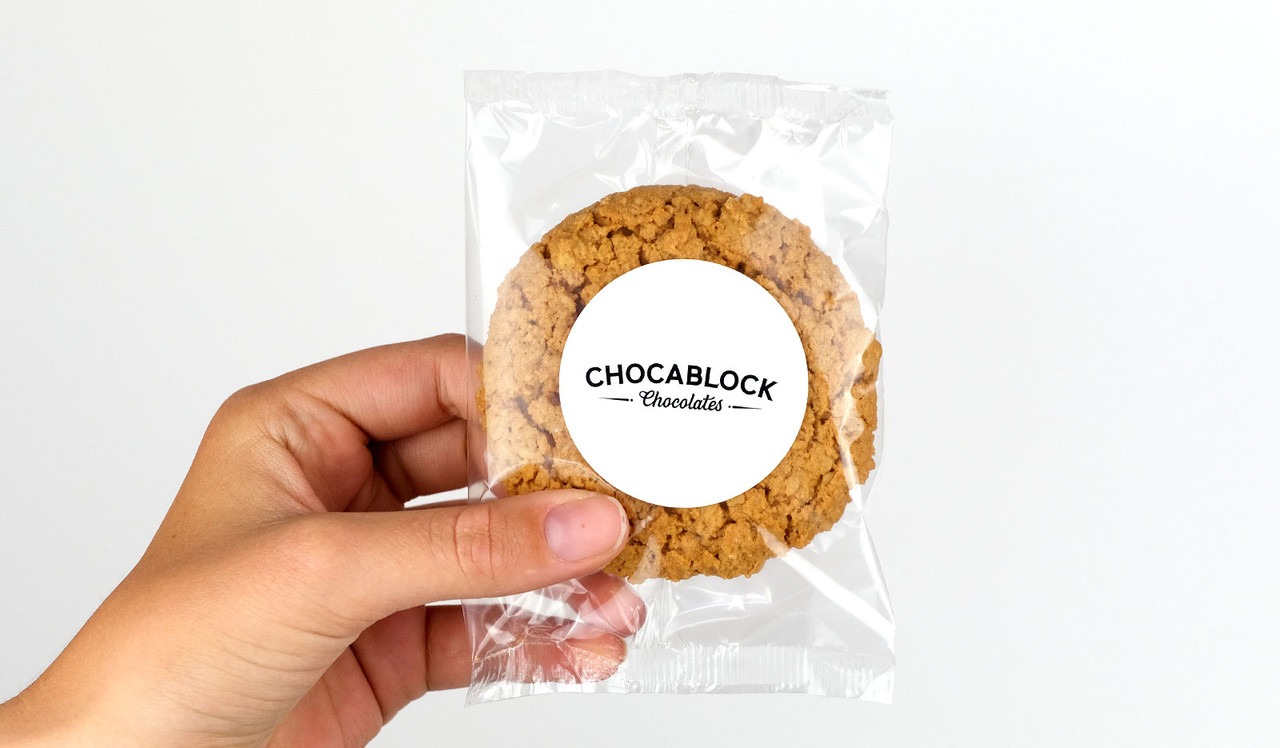 Model holding Anzac Biscuit for sizing purposes