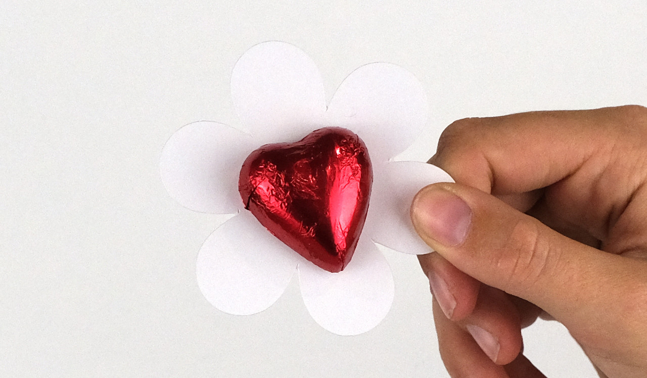 Model holding flower shaped card for sizing purposes