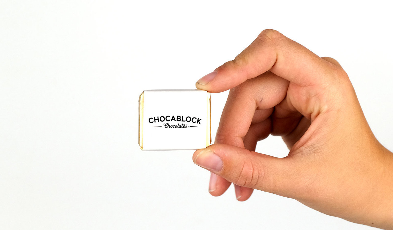 Model holding mini chocolate for size reference