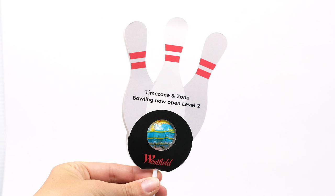 Model holding Ten Pin Bowling Lollipops In Custom Pop Holder
