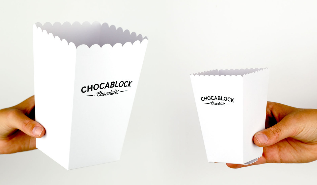 Size comparison of regular and large popcorn boxes