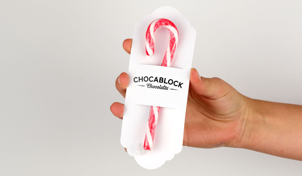 Model holding candy cane card for sizing purposes