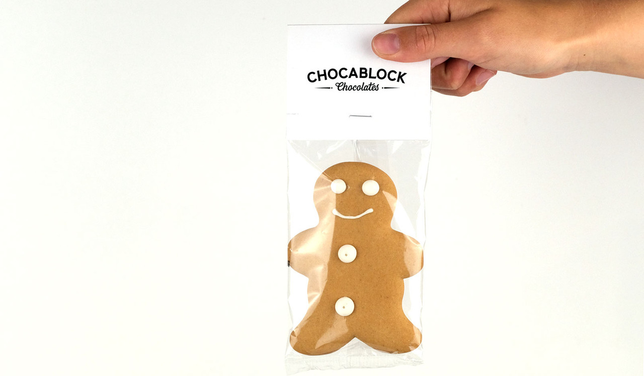 Model holding gingerbread man for sizing purposes