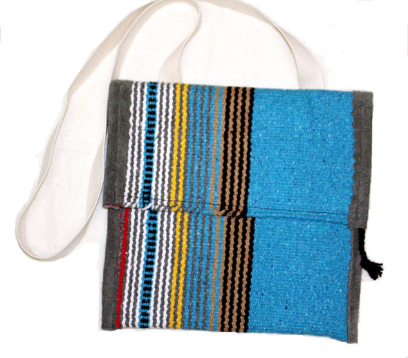 Haversack made from horse blanket with leather trim, canvas lining, 7-inch flap, woven cotton shoulder strap, and full-width inside pocket.