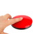 Finger pressing top of Big Buddy Button Red