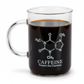 Glass beaker-style coffee mug filled with black coffee and labeled with a caffeine molecule design