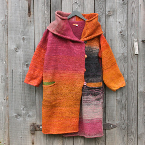 One of a kind felted wool coat knit by Inese with colors inspired by gerberas. Size S Photographed on my woodshed with shawl collar