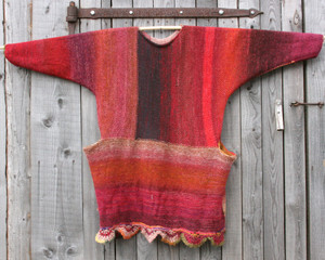 Cranberries inspired scalloped hem sweater reversible dress hung on wood pole on side of woodshed, purl side out, knit by Wrapture by Inese