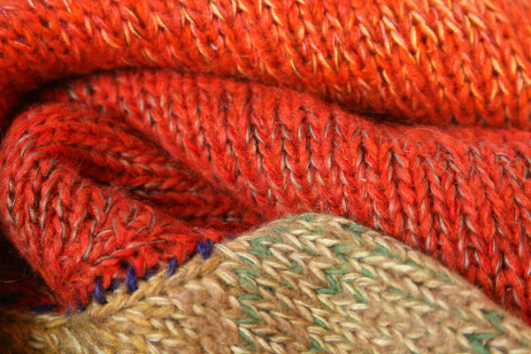 Fall Sky orange rust closeup of knitting detail showing how Inese does her unique color blends