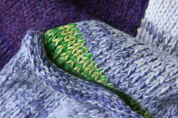 Pansies Liene Sweater Coat purple knitting detail closeup of Ineses unique way of blending colors in her knits, green pocket and collar, Wrapture by Inese