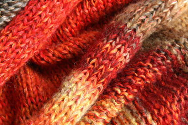 detail of knitting Maple Leaves inspired shawl wrap knit by Inese for Wrapture by Inese in red, gold, taupe ombre knit