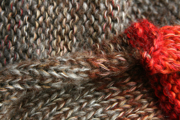 detail of knitting Maple Leaves inspired shawl wrap knit by Inese for Wrapture by Inese in red, gold, taupe ombre knit