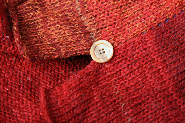 detail of side slit and button with ombre color change in knit Sumac dress, knit by Inese Iris Liepina of Wrapture by Inese