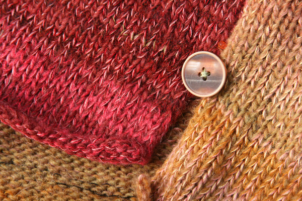 closeup of side slit and button detail in rose hips calf length tank dress knit by Inese Iris Liepina