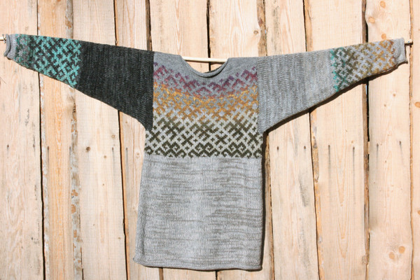 Heather Grey Latvian symbols sweater flat on side of woodshed size L