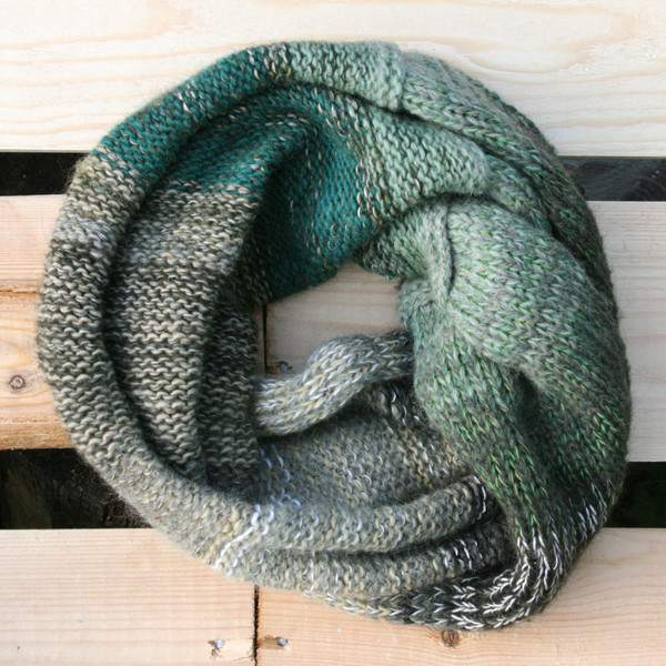 Forest Greens color way snood cowl flat on wood pallet background, knit by Inese Iris Liepina for Wrapture by Inese.