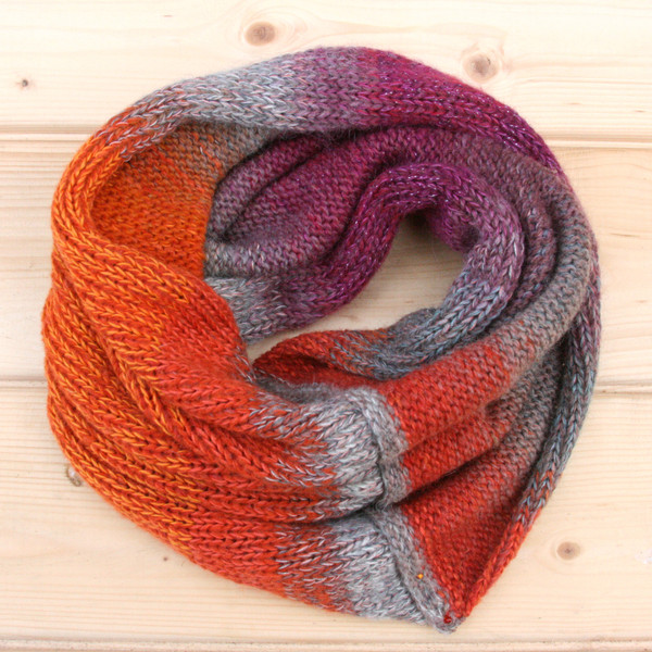 Gerberas color way snood cowl flat on wood pallet background, knit by Inese Iris Liepina for Wrapture by Inese.