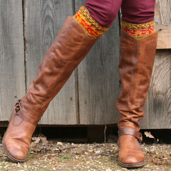 Sun sign boot toppers in Hawthorn color way hand knit by Inese Iris Liepina worn with knee high boots