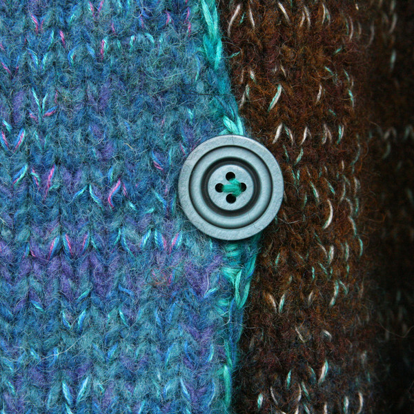 closeup detail of button on South Island inspired felted boiled wool coat