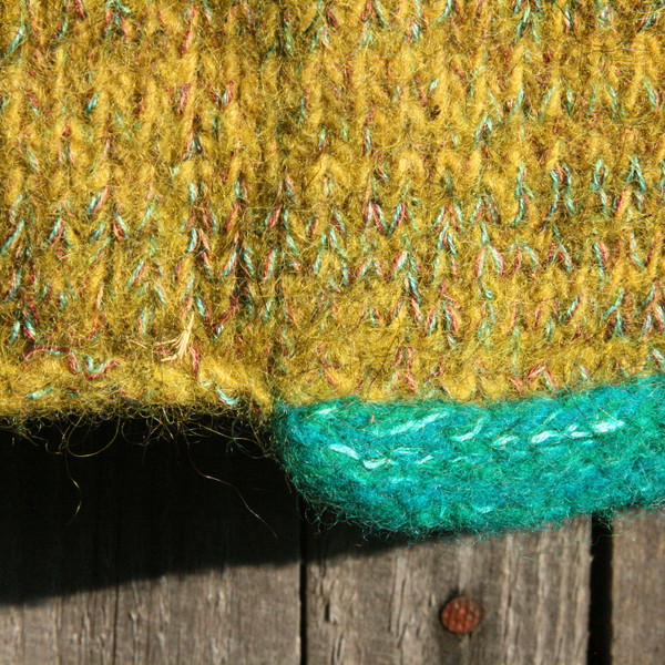 detail of pocket edge on Beetle colors inspired boiled wool hoodie jacket by Wrapture by Inese