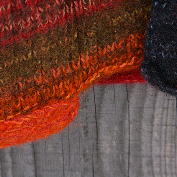 detail of pocket edge of Campfire colors inspired boiled wool hoodie jacket by Wrapture by Inese