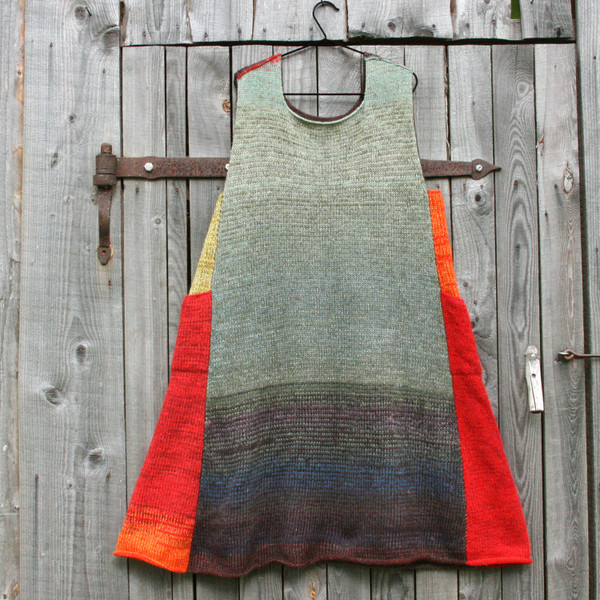 Rowan Berry trapeze dress on coathanger hung on woodshed door knit by Inese iris Liepina of Wrapture by Inese