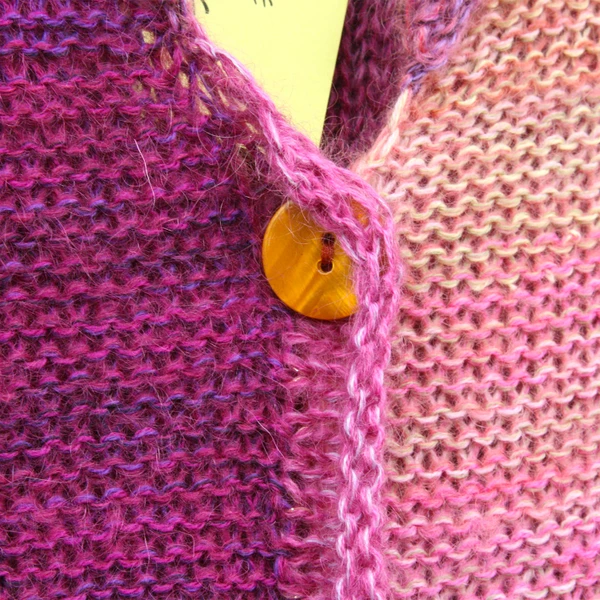 Aurora with purl side showing cardigan with mismatched buttons