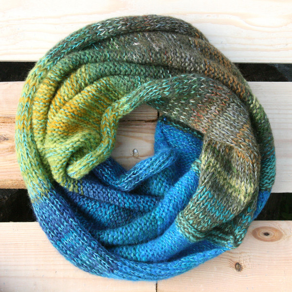 Mongolian Trek color way snood cowl flat on wood pallet background, knit by Inese Iris Liepina for Wrapture by Inese.