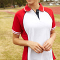 White polo with red raglan sleeves and navy contrast placket featuring striped collar and cuff details